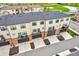 An aerial view of a neighborhood with townhomes, green spaces, and a community pond at 2578 Filson St, Carmel, IN 46032