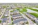 Scenic aerial view of a community featuring diverse homes, a pond, and recreational facilities at 2578 Filson St, Carmel, IN 46032
