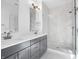 Bathroom featuring double vanity with granite countertop and tiled shower at 2578 Filson St, Carmel, IN 46032