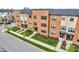 Brick townhomes featuring modern architecture, landscaped lawns, and street parking at 2578 Filson St, Carmel, IN 46032