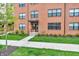 Brick townhome with a covered entry, landscaped lawn, and a concrete walkway at 2578 Filson St, Carmel, IN 46032