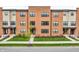 Modern brick townhomes featuring well-manicured lawns, a walkway, and large windows at 2578 Filson St, Carmel, IN 46032