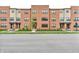 Modern brick townhomes featuring well-manicured lawns, a walkway, and large windows at 2578 Filson St, Carmel, IN 46032