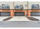 View of a home with a three-car garage, brick accents and small balconies at 2578 Filson St, Carmel, IN 46032