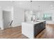 Modern kitchen with large island, gray cabinets, pendant lights and an open floor plan at 2578 Filson St, Carmel, IN 46032