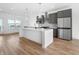 Modern kitchen with a large island, stainless steel appliances, and sleek gray cabinets at 2578 Filson St, Carmel, IN 46032