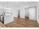 Modern kitchen with a large island, gray cabinets, pendant lighting, and a sliding barn door at 2578 Filson St, Carmel, IN 46032