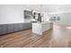 Bright, open kitchen boasts gray cabinetry, stainless appliances, a spacious island, and hardwood floors at 2578 Filson St, Carmel, IN 46032