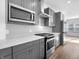 This kitchen features gray cabinets, subway tile backsplash, and stainless steel appliances at 2578 Filson St, Carmel, IN 46032