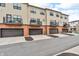 Street view showcasing townhomes with brick accents, garages, and balcony spaces for a cohesive community appearance at 2578 Filson St, Carmel, IN 46032