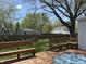 A backyard featuring a wooden deck with built-in benches, a fire pit, and a large, grassy area, ideal for outdoor entertainment at 2843 Canterbury Ln, Indianapolis, IN 46220