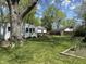 Backyard view with a lush lawn, wooden deck, and mature trees offering shade at 2843 Canterbury Ln, Indianapolis, IN 46220