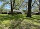 Charming single-story home with a well-manicured lawn and mature trees, creating a serene curb appeal at 2843 Canterbury Ln, Indianapolis, IN 46220
