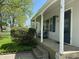 Inviting front porch with seating, arched trim, and a charming entrance to the home at 2843 Canterbury Ln, Indianapolis, IN 46220