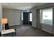 Bright living room showcasing neutral walls, plush carpeting, and large windows, creating a comfortable space at 2843 Canterbury Ln, Indianapolis, IN 46220