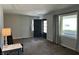 Sun-filled living room with carpet flooring, grey walls, and natural light coming through large windows at 2843 Canterbury Ln, Indianapolis, IN 46220