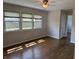Sunlit living room with gleaming hardwood floors and large windows offering neighborhood views at 2843 Canterbury Ln, Indianapolis, IN 46220