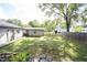 A spacious backyard with a mix of green grass, shaded areas, and partial fencing at 2909 Huntsville Rd, Pendleton, IN 46064