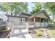 The home features a spacious backyard with a raised deck, cozy porch, and mature landscaping at 2909 Huntsville Rd, Pendleton, IN 46064