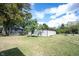 A spacious backyard with a mix of green grass, shaded areas, and a storage shed at 2909 Huntsville Rd, Pendleton, IN 46064