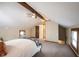 Bright bedroom with exposed beams and an adjacent bathroom at 2909 Huntsville Rd, Pendleton, IN 46064