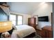 Well-lit bedroom with vaulted ceiling, built-in storage and wood-look floors at 2909 Huntsville Rd, Pendleton, IN 46064
