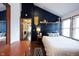 Vaulted ceiling bedroom with dark accent wall, wood-look floors, and decorative shelves at 2909 Huntsville Rd, Pendleton, IN 46064