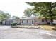 Charming single-story home with a well-manicured yard, red trim, and detached two car garage at 2909 Huntsville Rd, Pendleton, IN 46064