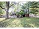 Charming home exterior featuring a well-manicured lawn and mature trees providing shade at 2909 Huntsville Rd, Pendleton, IN 46064