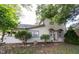 Home exterior featuring a covered porch, neatly trimmed bushes, and well-maintained landscaping at 2909 Huntsville Rd, Pendleton, IN 46064
