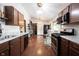 Open kitchen layout with wooden cabinets, stainless steel appliances, and an eat-in nook near the window at 2909 Huntsville Rd, Pendleton, IN 46064
