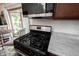 Stainless steel gas range in kitchen featuring granite countertops, wood cabinets, and a breakfast nook at 2909 Huntsville Rd, Pendleton, IN 46064