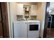 Laundry area with white washer and dryer units, and storage cabinets above at 2909 Huntsville Rd, Pendleton, IN 46064