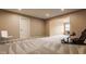 Finished basement area featuring neutral carpet, connecting room and a modern racing seat at 311 2Nd Ne St, Carmel, IN 46032