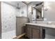 Bathroom featuring a glass shower with marble tile and vanity with marble countertop and modern mirror at 311 2Nd Ne St, Carmel, IN 46032
