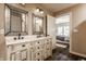 Bathroom with distressed double sink vanity, ornate mirrors, and a bedroom view at 311 2Nd Ne St, Carmel, IN 46032