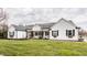 Charming home with white siding, black shutters, a manicured lawn, and inviting front porch at 311 2Nd Ne St, Carmel, IN 46032