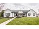 Charming home with white siding, black shutters, a manicured lawn, and inviting front porch at 311 2Nd Ne St, Carmel, IN 46032