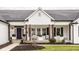 Inviting front porch with seating, brown wood columns, and charming decor at 311 2Nd Ne St, Carmel, IN 46032