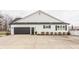 Charming home with a spacious garage and well-maintained landscaping, showcasing curb appeal and functionality at 311 2Nd Ne St, Carmel, IN 46032