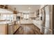 Bright, spacious kitchen features white cabinets, stainless steel appliances, and hardwood floors at 311 2Nd Ne St, Carmel, IN 46032