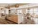 Open-concept kitchen with large island, stainless steel sink, and hardwood flooring at 311 2Nd Ne St, Carmel, IN 46032
