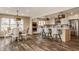Eat-in kitchen with white cabinetry, stainless steel appliances, and modern pendant lighting at 311 2Nd Ne St, Carmel, IN 46032