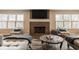 Living room with fireplace, TV, two chairs, and hardwood flooring at 311 2Nd Ne St, Carmel, IN 46032