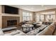 Warm living room features a fireplace, comfortable seating, and a view of the dining area at 311 2Nd Ne St, Carmel, IN 46032