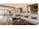 Open-concept living room with a comfortable sofa and seamless flow into the kitchen and dining area at 311 2Nd Ne St, Carmel, IN 46032