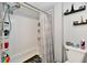 Bathroom featuring white wall tiles, a shower with curtain and shelving at 3142 N Euclid Ave, Indianapolis, IN 46218