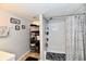 Secondary bathroom with towels, decorative art, shower with curtain and shelving at 3142 N Euclid Ave, Indianapolis, IN 46218