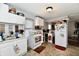Well-lit kitchen with appliances, cabinetry, stainless sink, and tile flooring at 3142 N Euclid Ave, Indianapolis, IN 46218