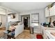 Functional kitchen area with laundry machines, sink, and a view into the living room at 3142 N Euclid Ave, Indianapolis, IN 46218